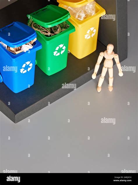 Wooden Model Of Human And Three Color Coded Recycle Bins Isometric