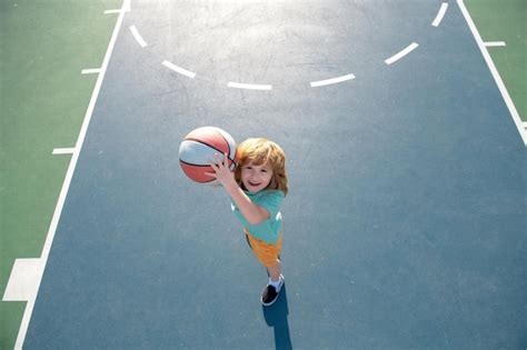 Premium Photo Child Shooting Basketball Ball And Playing Basketball