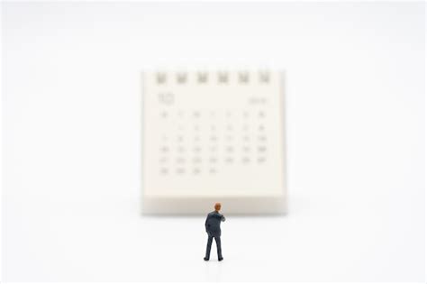 Premium Photo Miniature People Businessmen Standing On White Calendar