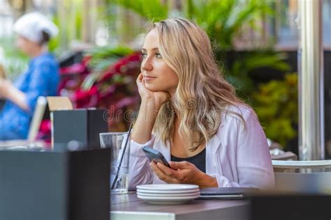 Lovely Hungarian Blonde Model Enjoys A Meal In An Outdoor Patio Stock Photo Image Of Coed