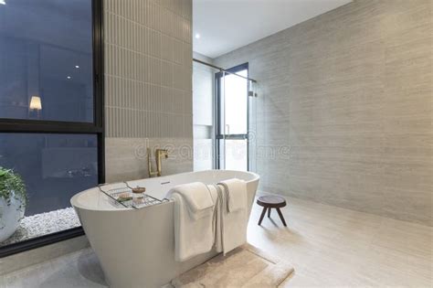 Modern White Bathroom Design With Freestanding Bathtub Stock Photo
