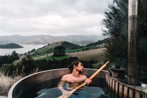 Caucasian Boy Without Clothes Bathing Sleeping Holding Long Wooden Shovel Inside Metallic Hot