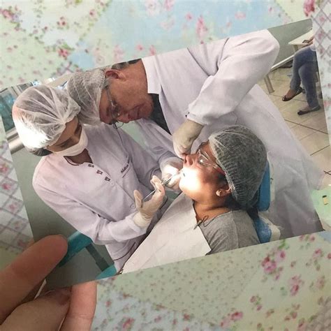 A Man Getting His Teeth Checked By Two Doctors