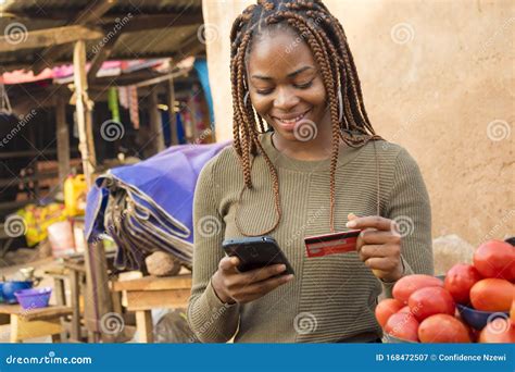 Young Nigerian Woman Selling in a Local Nigerian Market Using Her ...