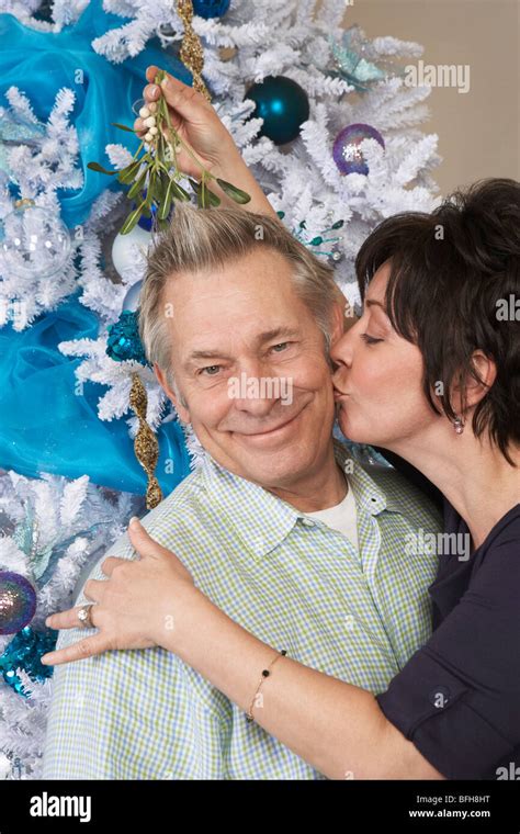 Couple Is Kissing Under The Christmas Tree Hi Res Stock Photography And