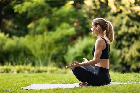 Premium Photo Sporty Blonde Woman Practicing Yoga At Public Park Side View