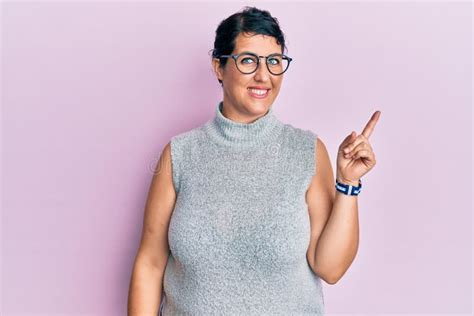 Plus Size Brunette Woman Wearing Casual Clothes And Glasses Smiling Happy Pointing With Hand And
