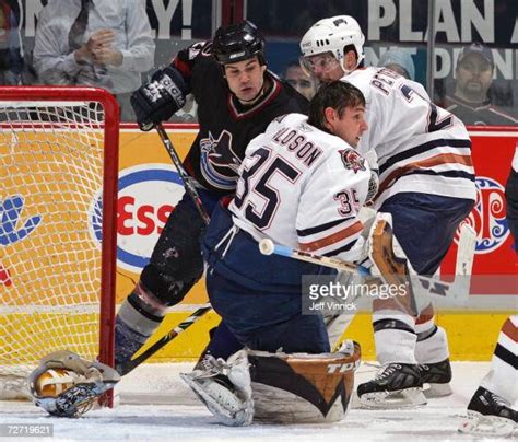 Dwayne Roloson of the Edmonton Oilers makes a save after losing his ...