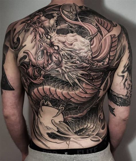 A Man With A Dragon Tattoo On His Back