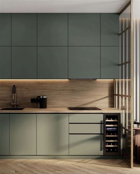 a modern kitchen with green cabinets and wood flooring on the walls ...