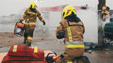 Two Firefighters On The Car Crash Accident Scene Stock Image Image Of