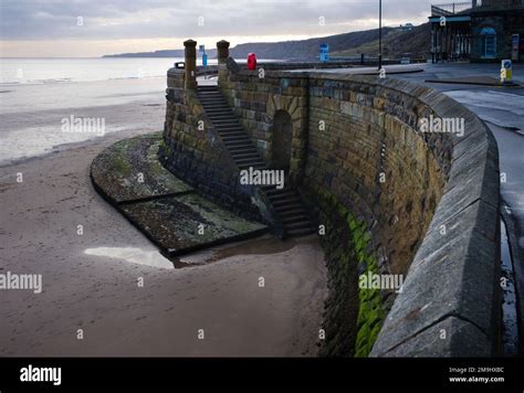 Sea Wall With Steps Leading Down To The Original Free Water Tap Or Spaw