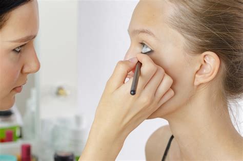 Premium Photo Novice Makeup Artist Applies Makeup To Model