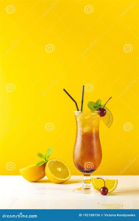 Glass With Water Drops Of The Sex On The Beach Cocktail On Yellow Background Close Up Shallow