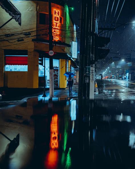 Hotel Neon Reflecting in a Street Puddle at Night · Free Stock Photo