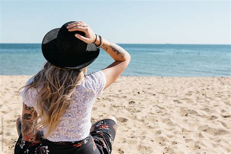 "Young Blonde Woman Sitting On The Beach Facing The Water" by Stocksy ...