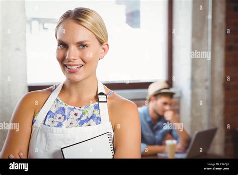 Smiling Blonde Waitress Posing In Front Of Customer Stock Photo Alamy