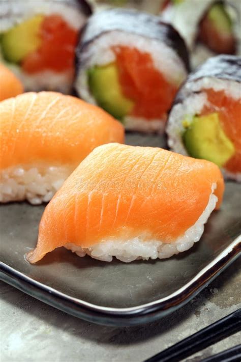 Close Up Of Sashimi Sushi Set With Chopsticks And Soy Sushi Roll With