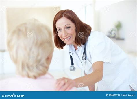 A Quick Checkup On A Patients Progress Friendly Mature Nurse Comforts Her Elderly Patient With