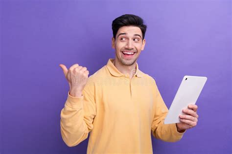 Photo Of Attractive Excited Man Dressed Yellow Shirt Typing Apple Samsung Device Thumb Empty