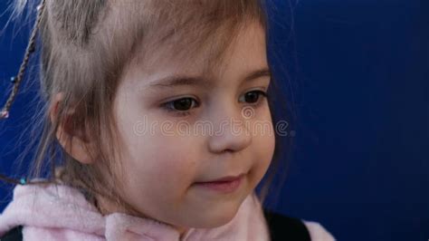 A Blonde Girl In A Sweater Smiles At The Camera And Waves A Magic Wand