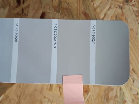 A Close Up Of A Paint Swatch With Pink Tape On It