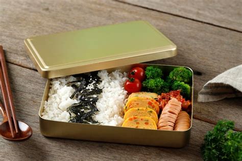 Premium Photo Dosirak Korean Lunch Box Contain Steamed Rice With Gyeranmari Sausage Kimchi