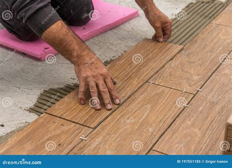 Worker Placing Ceramic Floor Tiles On Adhesive Surface Stock Image