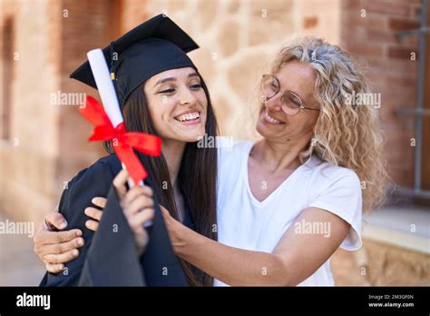 Two Women Mother And Graduated Daughter Hugging Each Other At Campus