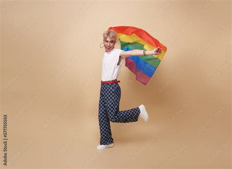 Youth Asian Transgender LGBT Showing Rainbow Flag Isolated On Nude Color Background Gender