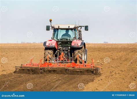 Farmer In Tractor Preparing Land With Seedbed Cultivator Stock Image