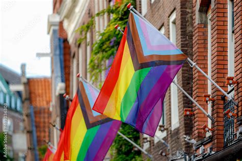Progress Pride Flag New Design Of Rainbow Flag Waving In The Air With Blue Sky Symbol Of Gay