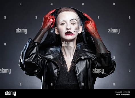 Woman In Black Leather Raincoat Taking Off Hood Stock Photo Alamy