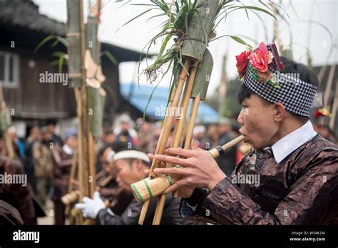 Chinese People Of Miao Ethnic Minority Dressed In Traditional Clothes Perform Lusheng To