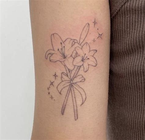 A Woman With A Tattoo On Her Arm Has A Bouquet Of Flowers In The Shape