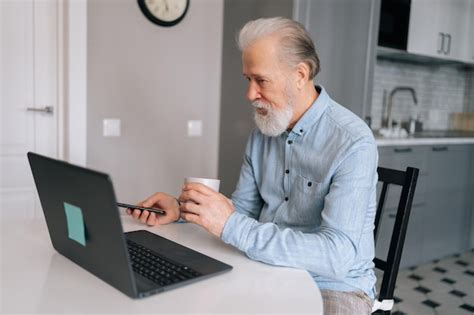Premium Photo Side View Of Grayhaired Mature Adult Business Man Working On Laptop Computer And