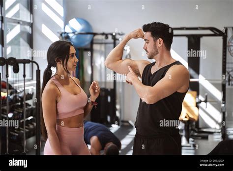 Fitness Brunette Woman Observes Her Partner With Doubts About How To