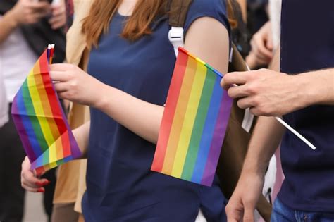 Premium Photo Concept Of Sexual Minority People Holding Gay Rainbow Flags Outdoors