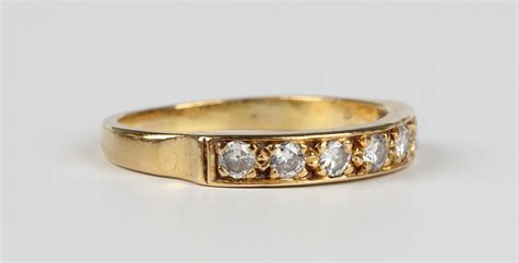 An 18ct Gold And Diamond Seven Stone Half Eternity Ring Mounted With A