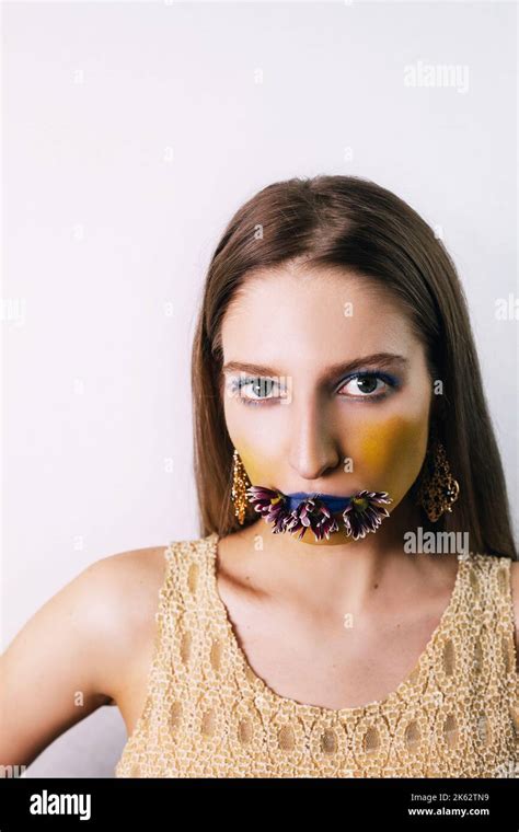 Portrait Of Pretty Blonde Girl With Extreme Blue Yellow Make Up She Is Wearing A Sleeveless