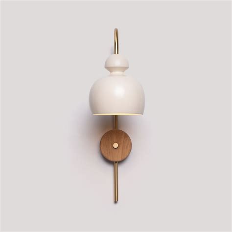 A White Wall Light With A Wooden Base