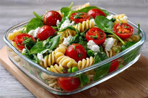 Fusilli Pasta Salad With Spinach Cherry Tomatoes Goat Cheese And Peas