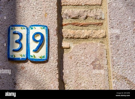 The Old Number 39 Sign Is Blue And White On The Wall The Concept Of