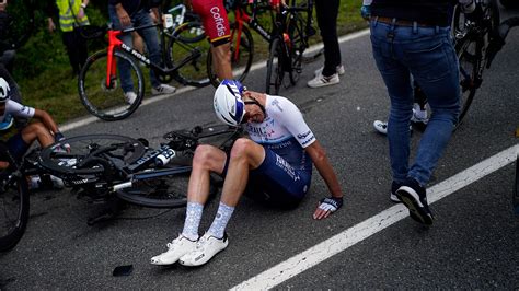 Fan holding sign causes huge crash during first stage of Tour de France ...