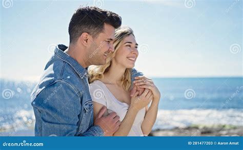 Man And Woman Couple Smiling Confident Hugging Each Other At Seaside