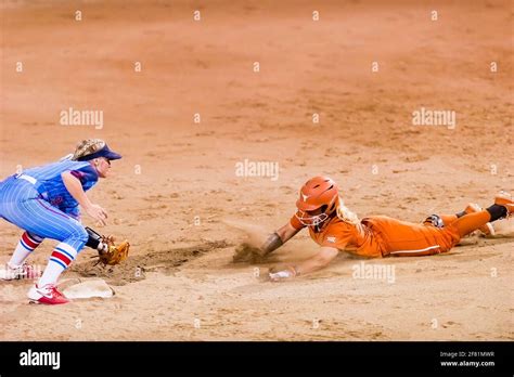 A Texas Longhorn Player Is Attempting A Stolen Base Against The Ole