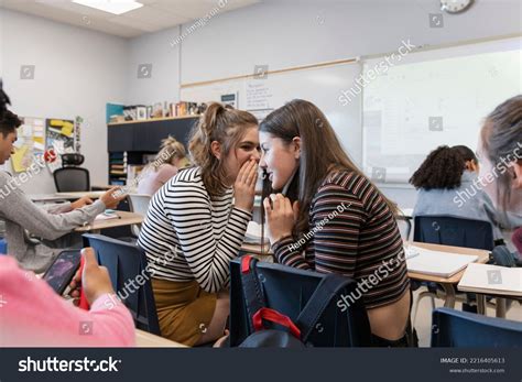 High School Girl Students Gossiping Classroom Stock Photo 2216405613