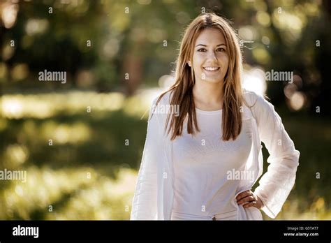 Beautiful Brunette Posing And Smiling In Nature Stock Photo Alamy
