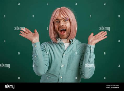 In Glasses Posing Having Fun Gay Man With Pink Hair Is Standing Against Green Background