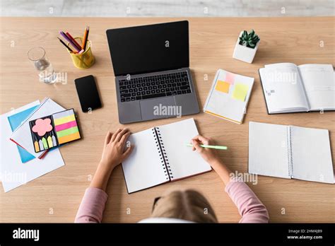 Blonde European Teenage Girl Study At Home With Computer With Blank Screen At Table In